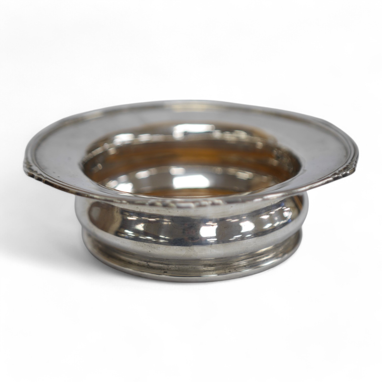 A George V silver mounted magnum coaster, by Maple & Co, Sheffield, diameter 19.1cm, 1929. Condition - poor to fair